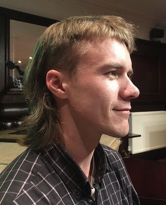 Man with mullet shows side profile